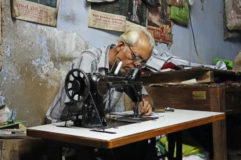 A one-armed tailor in Jamnagar.