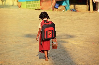 A little girl coming from school