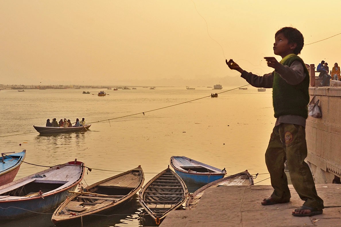 A boy flying his kite at the Ghats of Varanasi